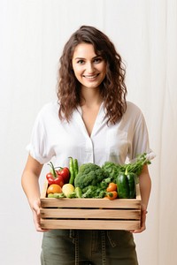 Vegetable wodden box holding adult woman. 