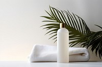 White cosmetic bottles towel white container. AI generated Image by rawpixel.