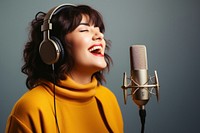 Woman singing microphone headphones headset. 