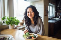 Asian woman kitchen smiling plate. AI generated Image by rawpixel.