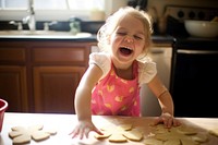 Kid baking cookies smiling baby innocence. 