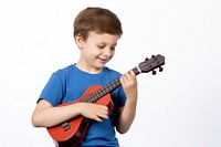 Kid playing toy ukulele musician smiling guitar. 