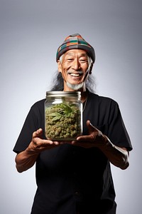 Male holding marijuana adult happy jar. 