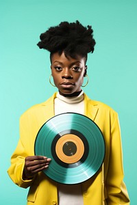 African afrobeat singer holding a small record portrait yellow adult. 