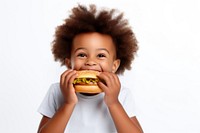 Cute little african boy enjoy eating a hamburger have fun biting food cute. AI generated Image by rawpixel.