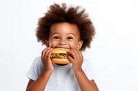 Cute little african boy enjoy eating a hamburger have fun biting food cute. 