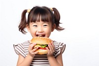 Cute little asian girl enjoy eating a hamburger have fun child food cute. 