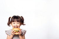 Cute little asian girl enjoy eating a hamburger have fun biting child cute. 