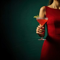 photo of woman hand holding red cocktail.  