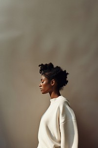 Black woman wearing white sweater portrait adult photo. 