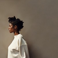 Black woman wearing white sweater portrait adult contemplation. 