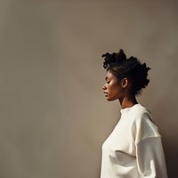 Black woman wearing white sweater portrait adult photo. 