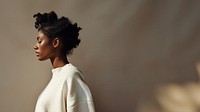 Black woman wearing white sweater portrait adult photo. 