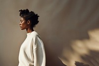 Black woman wearing white sweater portrait adult photo. 