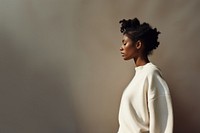 Black woman wearing white sweater portrait adult photo. 