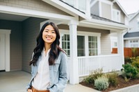 Smiling asian american woman standing house smile. 