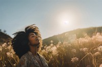 photo of happy black woman in a meadow.  