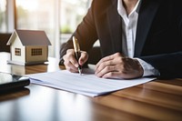 Man signing paper writing pen architecture. 