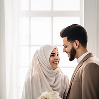 Cropped shot of muslim couple newlywed looking at each other, happy. 