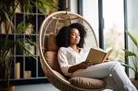 Reading book publication armchair sitting. 