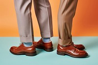 Men wearing shoe footwear standing clothing. 