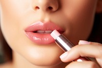 Cosmetics lipstick applying holding. 