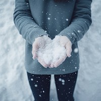 Holding snow glove outdoors midsection. 