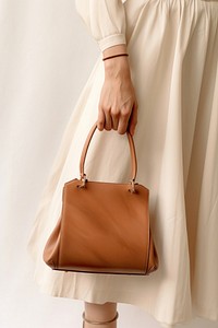 Woman hand holding bag handbag purse accessories. AI generated Image by rawpixel.