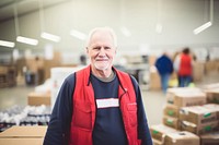 Mature man volunteering cardboard adult box. 