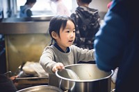 Child volunteering kitchen adult food. AI generated Image by rawpixel.