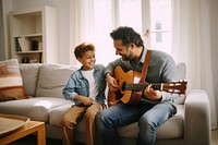 Dad teaching son play guitar musician adult togetherness. 