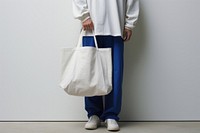 A white bag handbag person adult. 