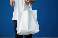 A white bag handbag person blue. 