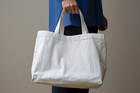 A white bag handbag person adult. 