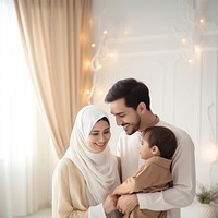 Happy Muslim family reading quran together smiling adult togetherness. 