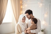 Happy Muslim family reading quran together smiling adult togetherness. 