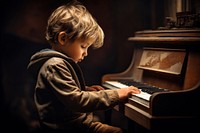 Little boy playing piano keyboard musician pianist. 