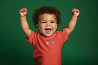 Cheering toddler in red t-shirt