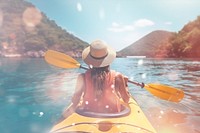 Woman kayaking with bokeh effect