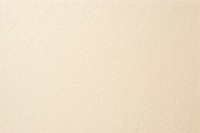 Beige paper texture backgrounds white wall. 