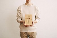 Man holding gift box sweater celebration anniversary. 