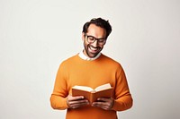 Man hold read Brown textbook beaming shiny smile enjoy wear spectacles orange pullover portrait sweater reading. AI generated Image by rawpixel.