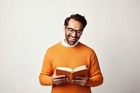 Man hold read Brown textbook beaming shiny smile enjoy wear spectacles orange pullover portrait sweater reading. 