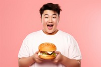 Chinese teenage guy hamburger holding eating. AI generated Image by rawpixel.