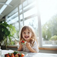 Strawberry eating child happy. 