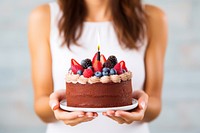 Birthday cake dessert holding berry. AI generated Image by rawpixel.