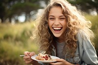 Eating laughing outdoors happy. 