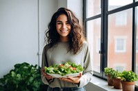 Happy Young woman holding salad smile adult plant. 