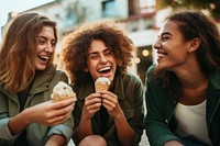 Young group laughing holding dessert. 