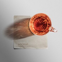 Paper napkin mockup psd with whiskey glass on top